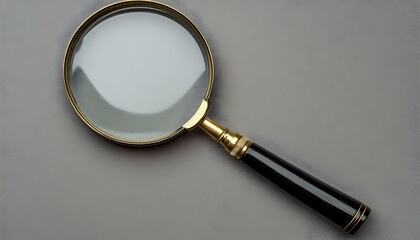 A top view of a single magnifying glass with a handle, isolated on a grey backdrop  