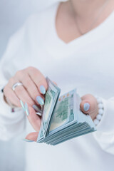 female hands holding American dollar paper bills