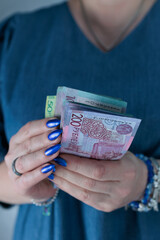 Female hands holding paper bills Belarusian rubles