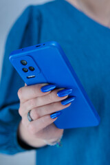 Woman's hands holding a large smartphone