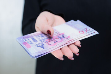 Female hands holding paper bills Belarusian rubles