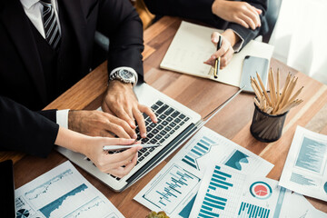 Diverse group of business analyst team analyzing financial data report paper on office table. Chart and graph dashboard by business intelligence analysis for strategic marketing planning Meticulous