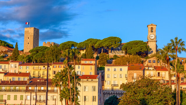 Cannes, France. Panoramic view of the castle and historical buildings of the old town of Cannes at golden hour.