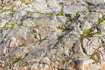 Abstract pattern on granite rock face on the side of a fjord in Prince Christian Sound in Greenland