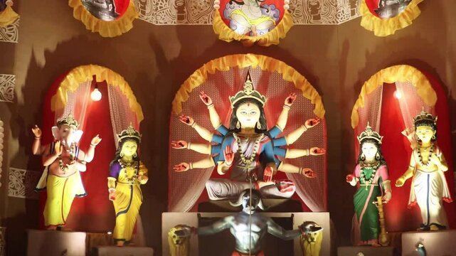 Hindu Goddess Durga idol from Durga Puja pandal known as Durgotsava or Sharodotsav.  Happy Navratri. Bangali Goddess Durga and other goddesses in Pandal.
