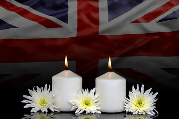 photo of beautiful flowers  and candles on black background