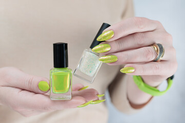 Female hand with long nails and neon yellow green manicure