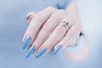 Womans hands with long nails light gray blue manicure	