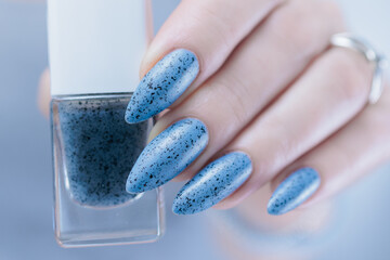 Womans hands with long nails light gray blue manicure	