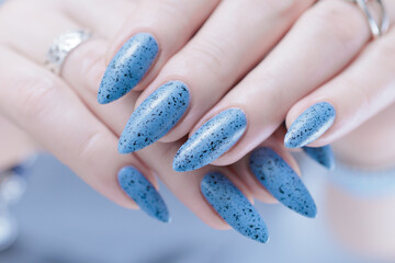 Womans hands with long nails light gray blue manicure	