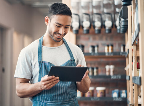 Small business, asian man and smile in cafe with tablet, product check and scroll for inventory management. Coffee shop, manager and barista with digital for stock quality, startup or online services
