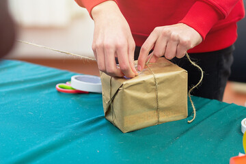 Man packing a gift in paper