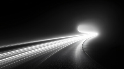 A long exposure photograph of a road at night, with light trails from moving vehicles creating a sense of motion and speed