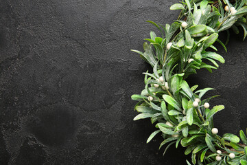Beautiful mistletoe wreath on black background