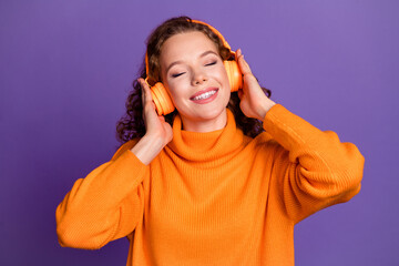 Photo of nice young girl closed eyes headphones wear pullover isolated on violet color background