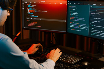 Working IT developer concentrating online software development information on surrounded by coding...