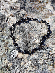 Black obsidian choker with tree of life pendant at gray granite rock surface | Natural stone chunky...