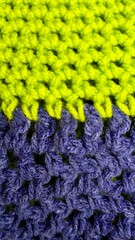 green and purple wool thread crochet texture . background close  . copy space . warm clothes