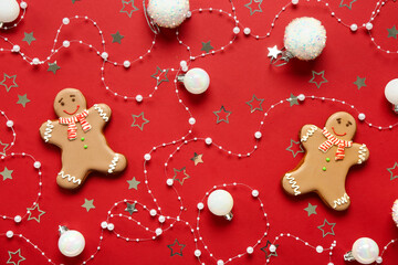 Christmas sweet gingerbread cookies and beautiful decorations on red background
