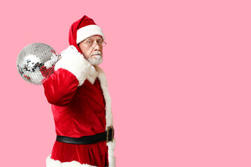 Santa Claus in glasses with disco ball on pink background