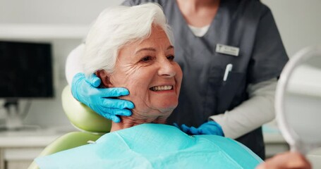 Consulting, mirror and senior patient at dentist for cleaning, oral hygiene and dentures. Smile, dental and healthcare advice with people at clinic for orthodontist, treatment and teeth exam - Powered by Adobe