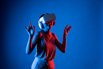 Smart female standing surrounded by neon light wearing VR headset connecting metaverse, future...