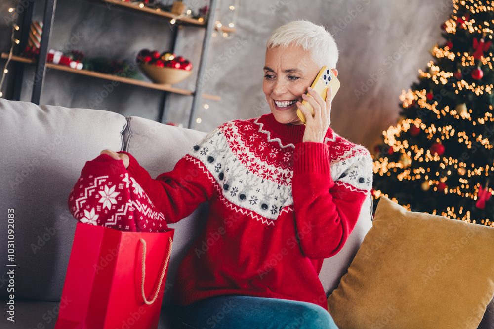 Canvas Prints Portrait of pretty aged woman speak phone sweater shop bag new year xmas garland lights flat indoors