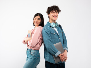 Modern Students. Happy Young Couple With Laptop And Workbooks Posing Standing Back To Back On White...