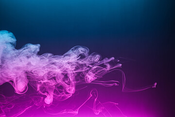 Twisted plume of smoke. The movement of smoke on a colored background. Abstract smoke lines