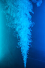 Twisted plume of smoke. The movement of smoke on a colored background. Abstract smoke lines