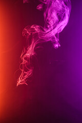 Twisted plume of smoke. The movement of smoke on a colored background. Abstract smoke lines