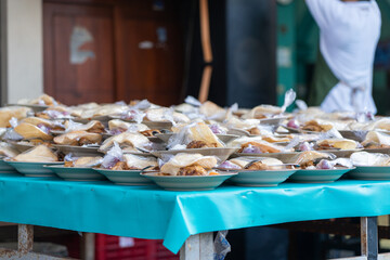 Table with dozens of free evening dinner meals given as an act of Islamic charity during Ramadan, near Jogokariyan Mosque, by pious muslims.