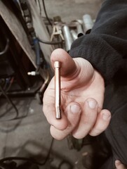 close up of a hand holding a wrench