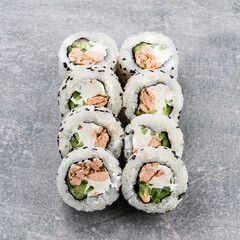 Maki sushi rolls with tuna, cucumber, cream cheese and sesame.