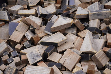 Pile of weathered wooden blocks in various shapes and sizes. Background or backdrop