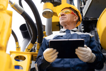 Offshore worker inspect with tablet drilling rig for exploration of minerals for oil, gas and...