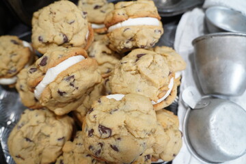 Freshly baked homemade chocolate chip whoopie pies with buttercream icing.  Just a fun classic cookie sandwich with icing.