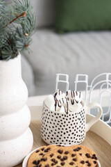 Cup of cocoa with marshmallows and cookies on tray, closeup