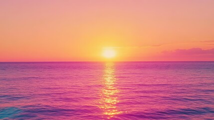 Obraz premium A vibrant, blurry sunset over a calm sea, with the sun reflecting on the water.