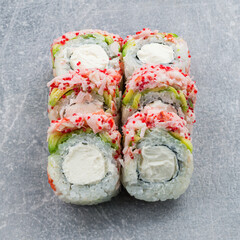 Set of maki sushi rolls with shrimp, avocado, cream cheese and red flying fish caviar.