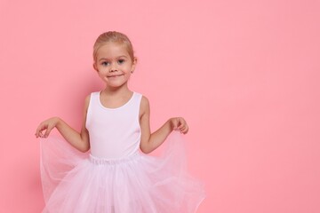 Little girl pretending to be ballerina on pink background, space for text. Dreaming of future profession