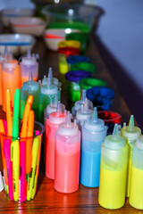 bottles filled with multicolored fluorescent paints for coloring pictures. children's bright colors.