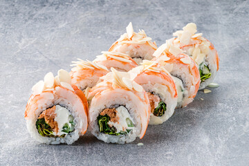 Set of sushi rolls with shrimp, tuna, cream cheese, cucumber, lettuce, rice and nori topped almond...