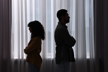 Couple having quarrel indoors at night. Relationship problems