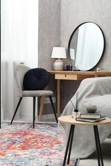 Mirror, dressing table, chairs and folding screen indoors. Interior design