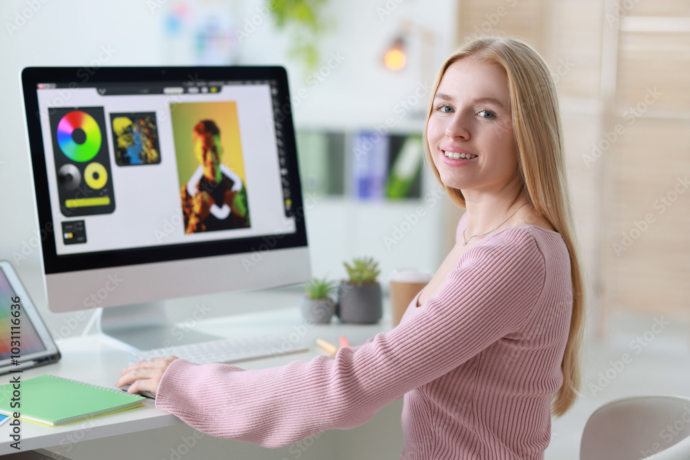 Poster graphic designer working with computer at table in office