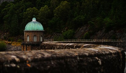 This photograph was taken on 10th August 2024 at Caban coch dam, England. This shot was caught in a moving car, driving over a raised bendy bridge at the dam.