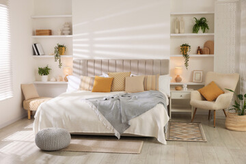 Comfortable large bed in beautiful room. Interior design