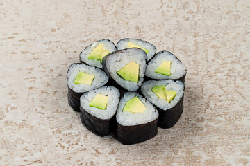 Traditional Japanese cuisine set of maki sushi rolls with avocado, rice and nori.