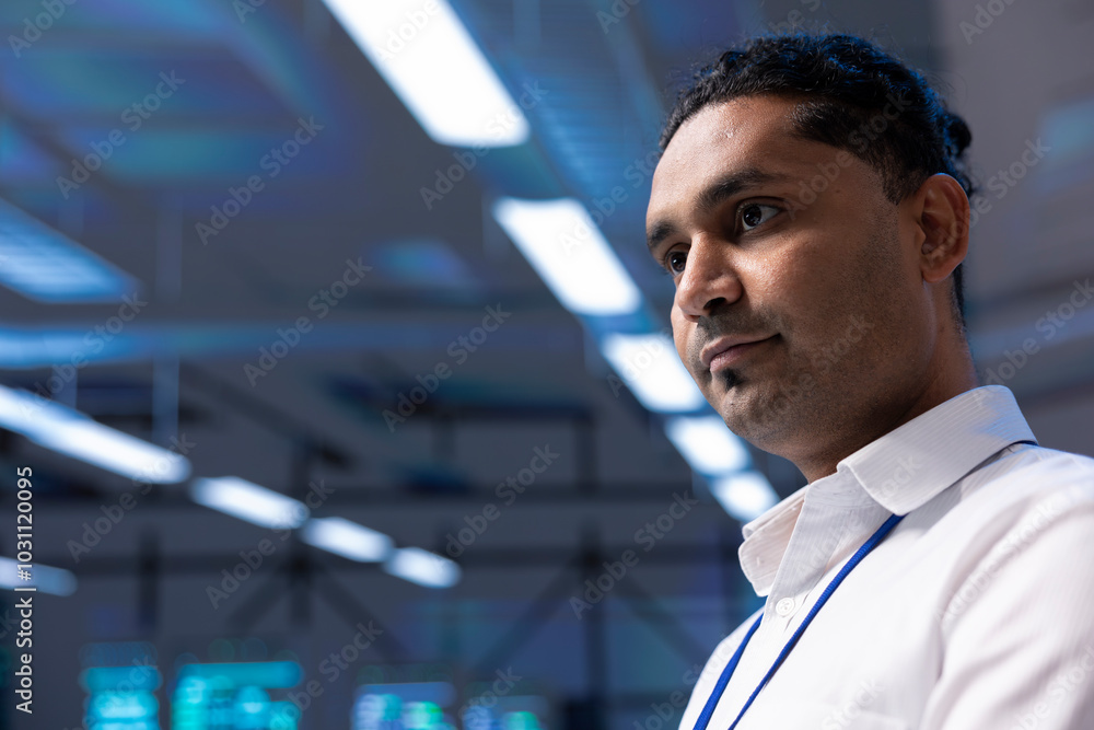 Poster engineer in data center walking through server racks used for computationally intensive tasks such a